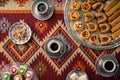 Turkish coffee and sweets served on colorful patterned carpet Royalty Free Stock Photo