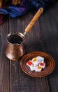 Turkish coffee and Turkish Delight over dark wooden background Royalty Free Stock Photo