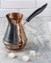 Turkish Cooper with freshly brewed coffee on marble table Royalty Free Stock Photo