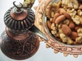 Turkish copper cookware handmade from Turks and candy dish with almonds and walnuts Royalty Free Stock Photo