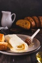 Turkish creamy dairy kaymak, honey and bread on a breakfast plate vertical view Royalty Free Stock Photo
