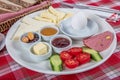 Turkish Cuisine Breakfast Plate. White breakfast plate with sliced cherry tomatoes, cucumber and boiled egg with on wooden table Royalty Free Stock Photo