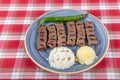 Turkish cuisine inegol meatballs. Grilled meatballs on a plate. Turkish Tekirdag or inegol Kofte with pepper, rice and mashed