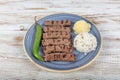 Turkish cuisine inegol meatballs. Grilled meatballs on a plate. Turkish Tekirdag or inegol Kofte with pepper, rice and mashed