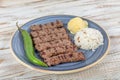 Turkish cuisine inegol meatballs. Grilled meatballs on a plate. Turkish Tekirdag or inegol Kofte with pepper, rice and mashed