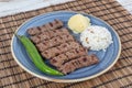 Turkish cuisine inegol meatballs. Grilled meatballs on a plate. Turkish Tekirdag or inegol Kofte with pepper, rice and mashed