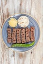 Turkish cuisine inegol meatballs. Grilled meatballs on a plate. Turkish Tekirdag or inegol Kofte with pepper, rice and mashed