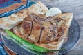 Turkish cuisine lamb ribs on pita bread. Tandoori style lamb chops and spiked pita served with green peppers and onions