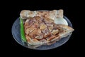 Turkish cuisine lamb ribs on pita bread. Tandoori style lamb chops and spiked pita served with green peppers and onions
