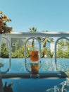 Turkish cup of tea against backdrop of blue sea, clear sky and green palm trees. summer holiday concept or beach Royalty Free Stock Photo