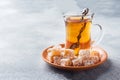 Turkish delight with hazelnut in carved metal bowl and tea in glass Cup, selective focus Royalty Free Stock Photo