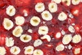 Nuts in red juice top view. Oriental sweets with hazelnuts background