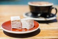 Turkish delight (lokum) confection with black tasting coffee. Royalty Free Stock Photo