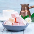 Turkish delight or lokum confection rose and lemon flavored with coffee and cezve, square format Royalty Free Stock Photo