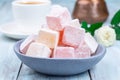 Turkish delight or lokum confection rose and lemon flavored with cup of coffee and cezve, closeup Royalty Free Stock Photo