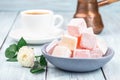 Turkish delight or lokum confection rose and lemon flavored with cup of coffee and cezve, horizontal Royalty Free Stock Photo