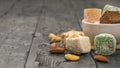 Turkish delight and nuts in a white cup on a wooden table. Oriental sweets