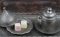 Turkish delight in traditional Ottoman style carved patterned metal plate and coffee cup