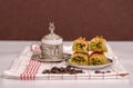 Turkish delights - baklava with turkish coffee, coffee beans on the white fabric and brown background Royalty Free Stock Photo