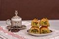 Turkish delights - baklava with turkish coffee, coffee beans on the white fabric and brown background Royalty Free Stock Photo