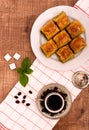 Turkish delights - baklava traditional sweets with turkish coffee, sugar the view from the top on wooden table and white Royalty Free Stock Photo