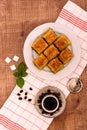 Turkish delights - baklava traditional sweets with turkish coffee, sugar the view from the top on wooden table and white Royalty Free Stock Photo