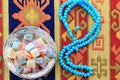 Turkish delights and blue rosary on traditional turkish carpet Royalty Free Stock Photo