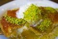 Turkish dessert kunefe, kunafa, kadayif with pistachio powder an Royalty Free Stock Photo