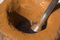 Turkish dibek coffee grinded in a large stone mortar