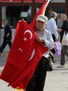 Turkish elderly man selling national flags on the square in front of the Egyptian Bazaar