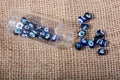 Turkish evil eye beads in bottle on canvas texture Royalty Free Stock Photo