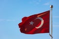 Turkish Flag aka Turk Bayragi isolated on blue sky background. Royalty Free Stock Photo