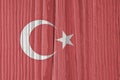 Turkish Flag on a dry wooden surface. Natural background or backdrop made of old wood. The official symbol of Turkey. Faded pale