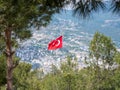 A Turkish flag flying high over Alanya city Royalty Free Stock Photo