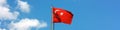 Turkish flag flying in the wind, with blue sky Royalty Free Stock Photo