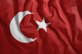 The Turkish flag is flying in the wind. Colorful, national flag of Turkey. Patriotism, a patriotic symbol