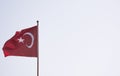 Turkish flag isolated on sky background moving in the wind. State symbol of Turkey Royalty Free Stock Photo