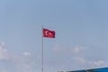 Turkish flag on a long flagpole fluttering in the wind Royalty Free Stock Photo