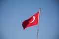 Turkish flag with red and white moon, blue sky Royalty Free Stock Photo