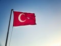 Turkish flag is waving against sky at the background Royalty Free Stock Photo