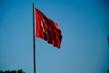 Turkish flag waving in blue sky. Royalty Free Stock Photo