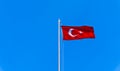 Turkish flag waving in blue sky Royalty Free Stock Photo
