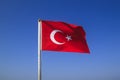 Turkish flag waving on the flagpole in the wind against the blue sky Royalty Free Stock Photo