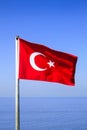 Turkish flag waving on the flagpole in the wind against the blue sky Royalty Free Stock Photo