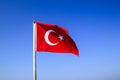 Turkish flag waving on the flagpole in the wind against the blue sky Royalty Free Stock Photo