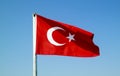 Turkish flag waving on the flagpole in the wind against the blue sky Royalty Free Stock Photo