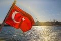 The Turkish flag is waving over Bosphorus in Istanbul, Turkey. Royalty Free Stock Photo