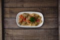 Fried aubergine or eggplant slices with tomato paste salsa sauce and cube potatoes on rustic wooden kitchen table Royalty Free Stock Photo