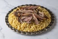 Turkish foods lamb shank tandoori on bulgur wheat rice (Turkish name bulgur bugday pilavi kuzu incik tandir