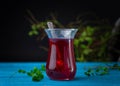 Turkish Fruit red tea in glass cup, on black background. summer season. concept of tea time and summer. Royalty Free Stock Photo